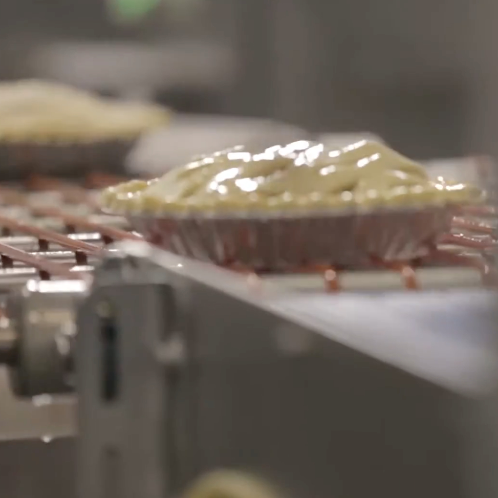 pies on conveyor belt